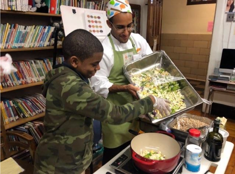 Chef Ricardo preparing a healthy meal with a student. 