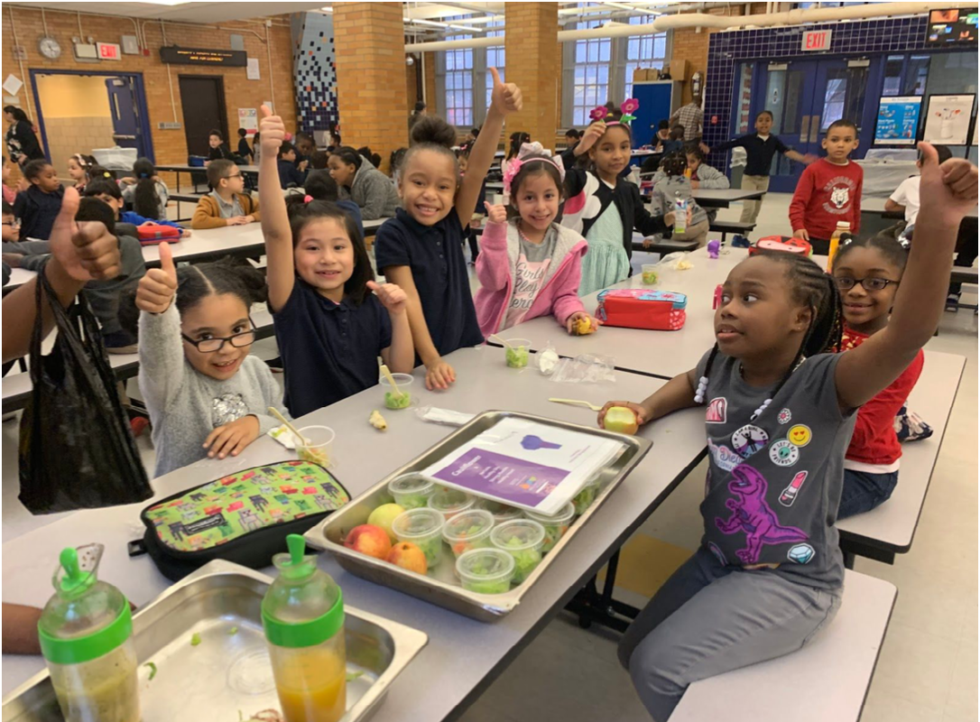 Students in the Cafeteria learning about healthy meals.
